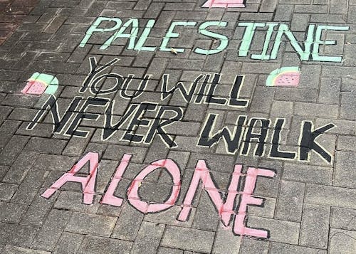 Chalk art created by Rutgers students in solidarity with Palestine sparked controversy as phrases like "One Holocaust does not justify another" are debated to be potentially antisemitic.
 – Photo by @sjbrutgersnb / Instagram