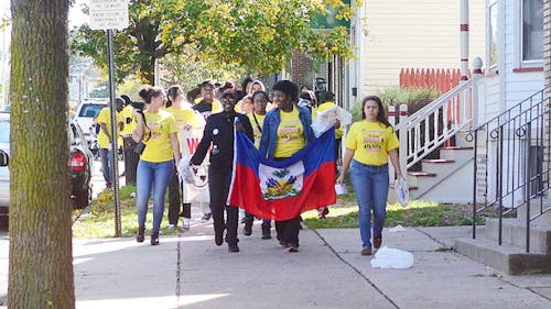 Students walk from the Douglass Campus Center to the Rutgers Student Center on the College Avenue campus Saturday to raise money for updated school supplies in Haiti through N.J.?for Haiti. – Photo by Lianne Ng