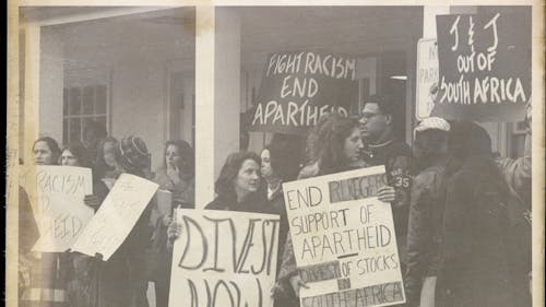 A 1977 rally against apartheid South Africa outside the Douglass Student Center was an early demonstration of the Rutgers community's divestment legacy. – Photo by scarletandblack.rutgers.edu