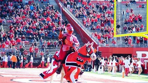 At Senior Night, Janine Puhak ended her four-year career as the first female Scarlet Knight in history. During her time at Rutgers, she kept her identity a secret, living a high profile double life beneath the armor. – Photo by Jeffrey Gomez