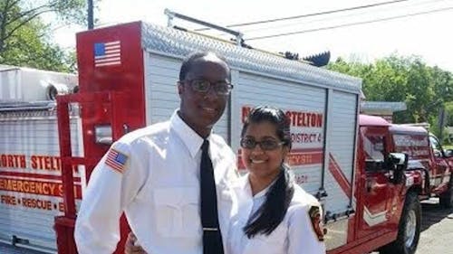 Courtesy of Brian Kenney | Hinal Patel and friend Brian Kenney smile for a photo in front of an emergency response vehicle. Hinal Patel, a 22-year-old EMT, was killed on July 25 when a car hit the ambulance as it was driving through an intersection in East Brunswick. – Photo by null