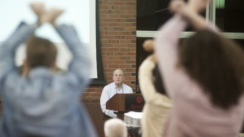 Students held their hands in X's over their head as President Robert L. Barchi spoke to protest the University's disregard for student input in hiring a new Director of the Office for Violence Prevention and Victim Assistance. – Photo by Dimitri Rodriguez