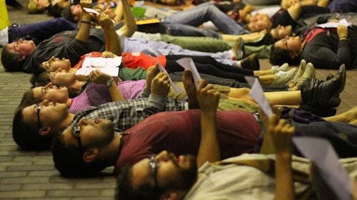 More than 20 students layed on the floor outside the College Avenue Student Center during an LGBTQ+ rally for safer spaces and communal acceptance after Tyler Clementi died by suicide on Sept. 23, 2010.  – Photo by The Daily Targum