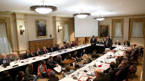Students sat in during the Board of Governors meeting on Dec. 6, demanding that Rutgers call itself a “sanctuary campus.” Earlier during the meeting, University President Robert L. Barchi called the school a “safe haven” for undocumented students. – Photo by Photo by Dimitri Rodriguez | The Daily Targum