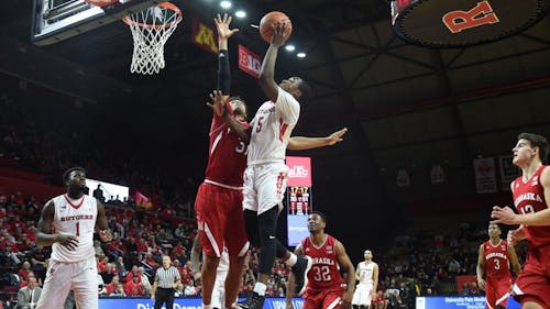 Mike Williams flies to the basket as Shavon Shields contends the layup attempt Saturday evening at the Rutgers Athletic Center. The sophomore guard posted a team-high 22 points on 7-for-12 shooting, but none of it mattered much as Nebraska buried Rutgers by 34 points in a 90-56 rout in Piscataway. – Photo by Michelle Klejmont