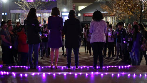 Students gathered on the steps of Brower Commons Tuesday night in support of survivors of dating and domestic violence. The candlelight vigil was part of the Office for Violence Prevention and Victim Assistance’s “Turn the Campus Purple” campaign. – Photo by Dimitri Rodriguez
