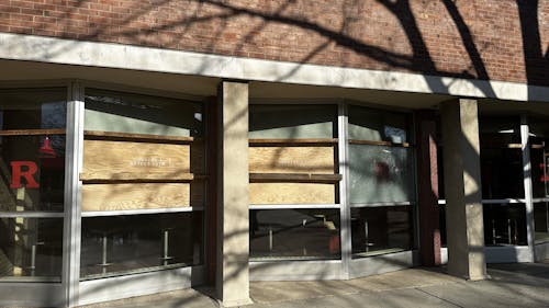 Frelinghuysen Hall on the College Avenue campus displays boarded up and shattered windows after an unidentified individual threw rocks at the residence hall on Thursday. – Photo by Arishita Gupta