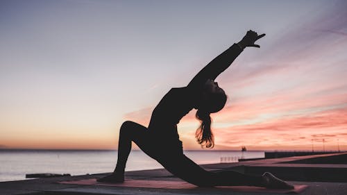 Incorporating a few yoga poses into your daily routine can help lower stress and prepare you for the day. – Photo by kike vega / Unsplash