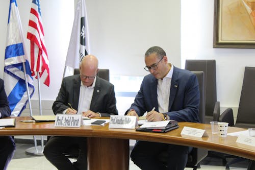 University President Jonathan Holloway in Israel signed an agreement with Tel Aviv University President Ariel Porat in the fall of 2021. – Photo by Courtesy of Carissa Sestito
