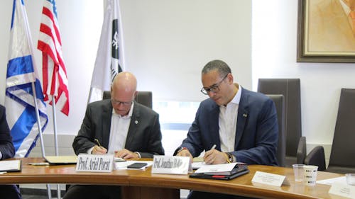 University President Jonathan Holloway signed an agreement in Israel yesterday with Tel Aviv University President Ariel Porat to further the partnership between the two universities. – Photo by Courtesy of Carissa Sestito