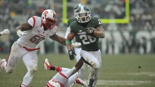 Michigan State running back Nick Hill sprints past Rutgers' struggling run defense for a 16-yard touchdown Saturday at Spartan Stadium. The Spartans exploded for five first-half touchdowns en route to a 45-3 romp, which marks the Knights' largest margin of defeat this season. – Photo by Shawn Smith