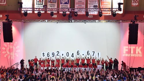 Rutgers University Dance Marathon staff hold up the total amount of money raised for the 17th annual Dance Marathon at the Louis Brown Athletic Center on the Livingston campus the evening of April 12. The amount of money raised this year exceeded last year’s total by approximately $70,000. TIAN LI / STAFF PHOTOGRAPHER – Photo by null