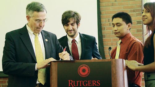 Congressman Rush Holt, D-N.J., signs an agenda presented by Spencer Klein, president of the New Jersey United Students. – Photo by Photo by Lianne Ng | The Daily Targum