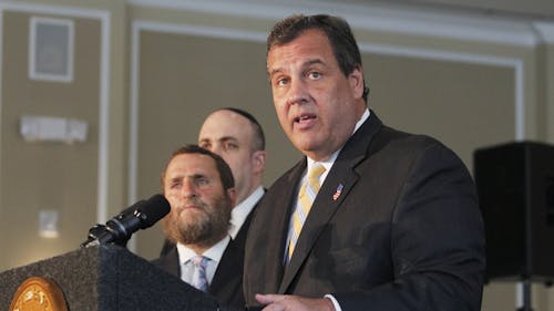 New Jersey Gov. and Republican presidential nominee Chris Christie speaks Tuesday morning at Rutgers' Chabad House on the College Avenue campus on August 25. Behind him, Rabbi Shmuley Boteach, founder of World Values Network, looks out onto the audience.  – Photo by Photo by Edwin Gano | The Daily Targum