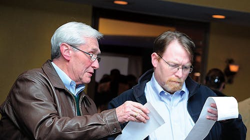 Two men at the Middlesex County Republican Organization event in
Edison check on poll results last night where various Republican
candidates lost their elections. – Photo by Photo by Jeffrey Lazaro | The Daily Targum