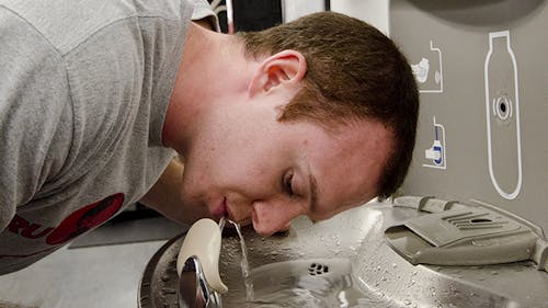 Rob Cavella, a graduate student, uses the hydration station in the College Avenue Gymnasium. – Photo by Julian Chokkattu