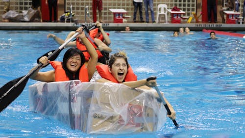 Thirty-three teams had one hour to engineer a canoe out of cardboard, duct tape and a garbage bag. They then raced across the recreation center pool. – Photo by Alexandra DeMatos