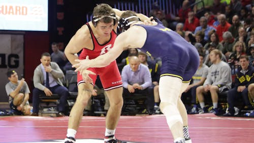 Junior 157-pounder Richie Lewis grapples with his opponent in Rutgers’ dual against Michigan. Lewis’ late takedown secured his win over No. 9 Brian Murphy. – Photo by Photo by Edwin Gano | The Daily Targum