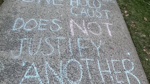 While chalk art is an acceptable form of protest, comparing the Israel-Hamas War to the Holocaust is an insensitive comment toward the Jewish population on campus.  – Photo by Yosef Fruhman