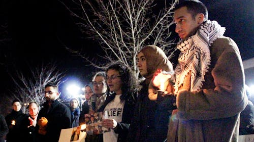 Students gather on the steps of Brower Commons to celebrate the lives of Deah Barakat, Yusor Abu-Salha and Razan Abu-Salha with a candlelight vigil. – Photo by Colin Pieters