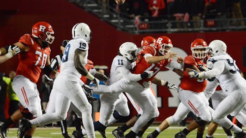 Sophomore quarterback Giovanni Rescigno gets tackled as he throws in the first quarter of Rutgers' 39-0 loss to No. 8 Penn State Saturday night. – Photo by Dimitri Rodriguez