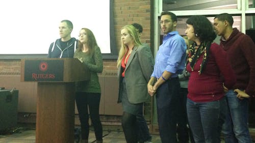 Allie Williams, a member of the Rutgers University Student Assembly, stands next to Matt Panconi, president of the assembly and with a group of students who co-authored a bill that proposed creating a sexual assault prevention committee.