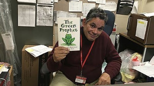 Nelson Seda, member of the University’s custodial services and author, showcases his personal interpretation of morality and ethics as inspired by his faith. “The Green Prophet” is 1 of 8 books published by Seda distributed to missionaries in countries across the world. – Photo by Rutgers.edu