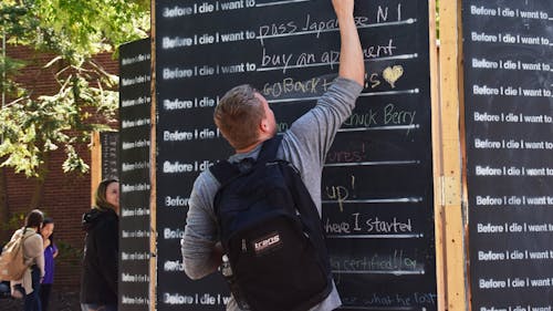 The Rutgers University Programming Association created the ‘Before I Die’ wall to encourage students to share experiences with one another and connect as a community. The wall will be making its way around the College Avenue, Cook and Livingston campuses. – Photo by Photo by The Daily Targum | The Daily Targum
