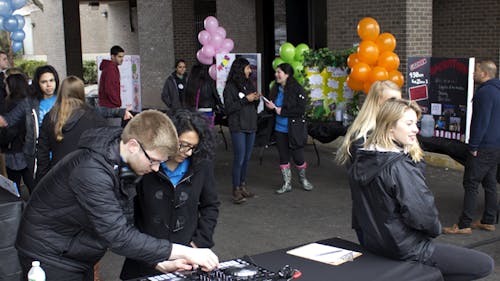 Students prepare for the lead-in to Rutgers University Dance Marathon 2015 with the “RUDM Dancer Expo,” held March 27 at Morrell Street, in front of the College Avenue Student Center.  – Photo by Colin Pieters