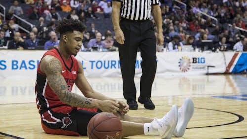 Sophomore guard Corey Sanders sits on the court after turning the ball over in the first half of Rutgers' loss to Northwestern in the second round of the Big Ten Tournament Thursday night. – Photo by Dimitri Rodriguez